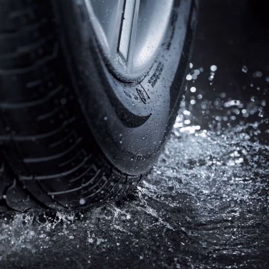 High Quality Commercial Tire Close-up of High Quality Commercial Tire driving over water puddle